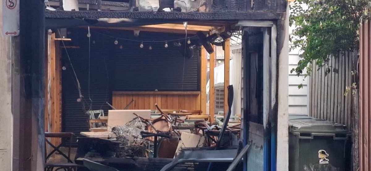 Burnt-out shopfront, gutted and open to the street